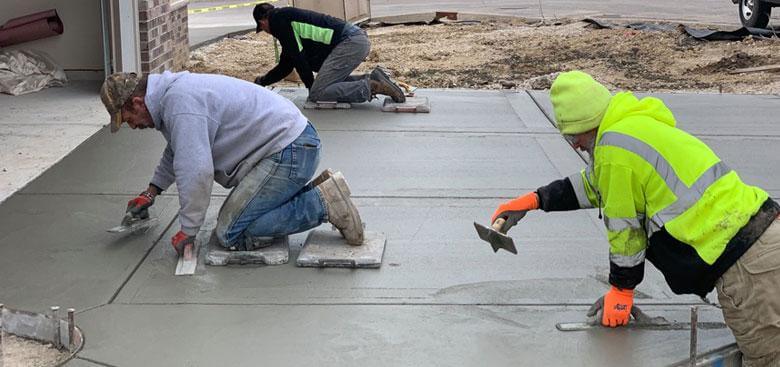 Victory Outdoor Services crew leveling concrete